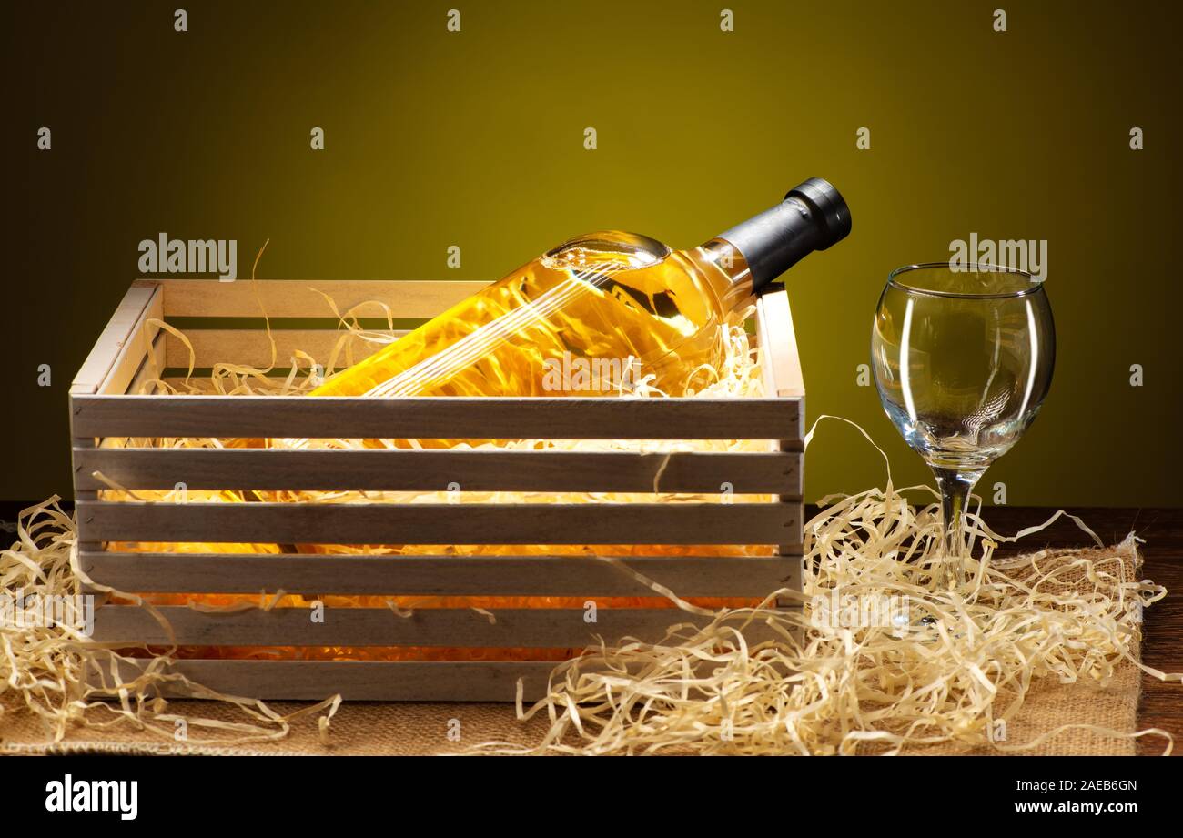 Download A Bottle Of White Wine With A Transparent Glass In A Wooden Box Shot On A Yellow Background Stock Photo Alamy PSD Mockup Templates