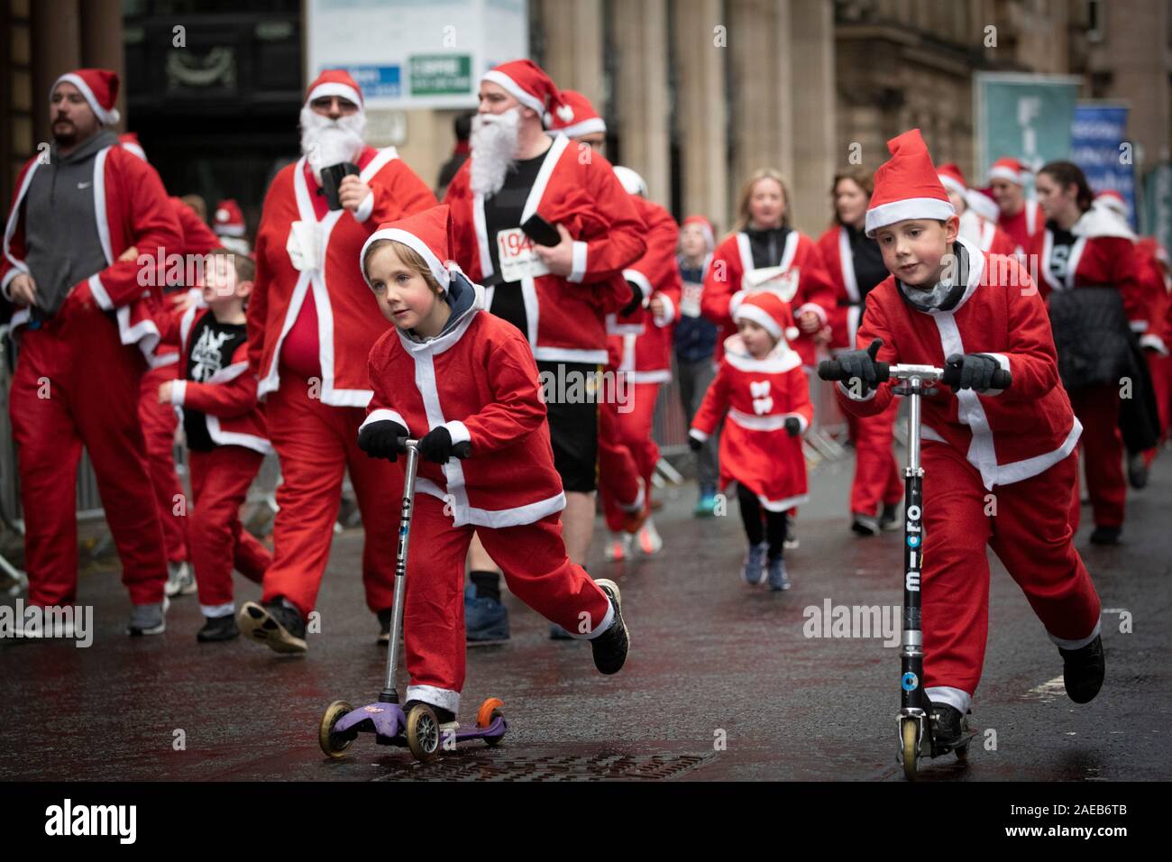 Over seven thousand members of the public taking part in Glasgow's annual Christmas Santa dash through the city centre. The Santa Dash has been held since 2006 and over the years has raised hundreds of thousands of pounds for charities working in and around Glasgow. Stock Photo