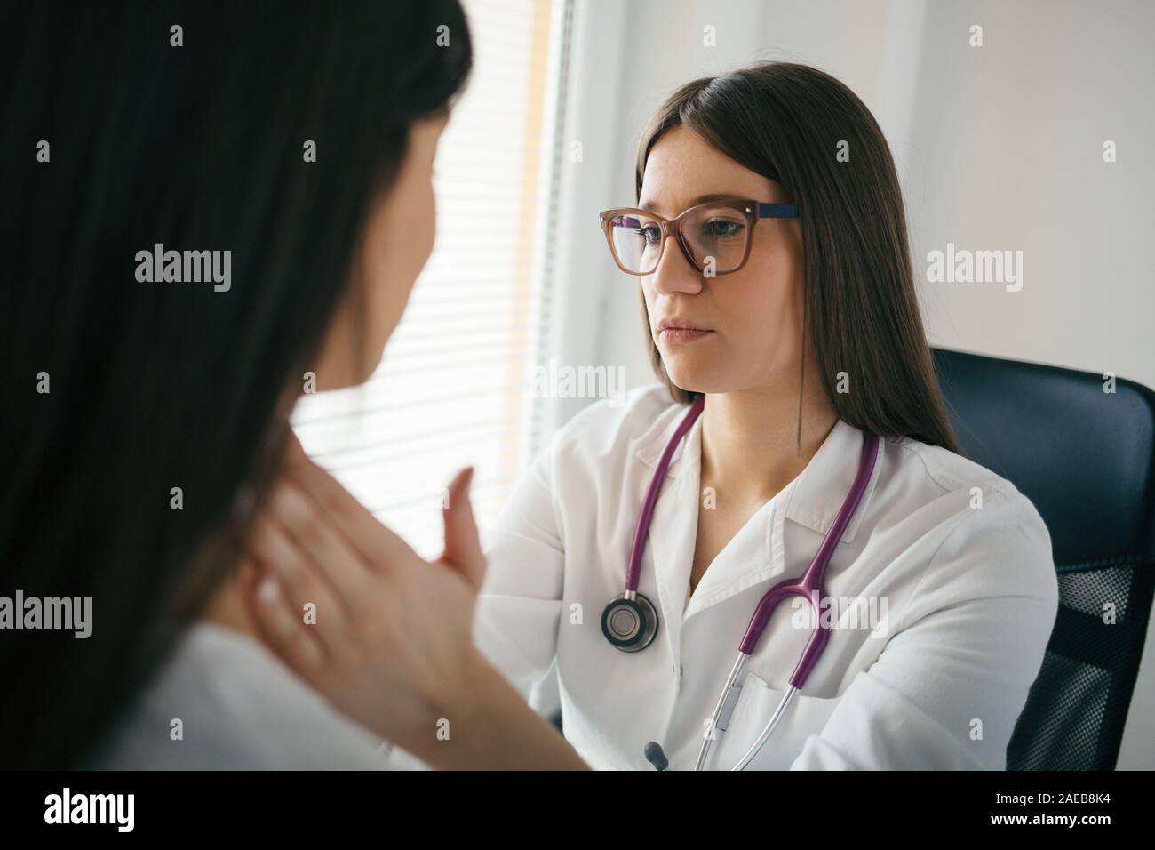 Medical exam. Female doctor palpating lymph nodes of a patient Stock Photo