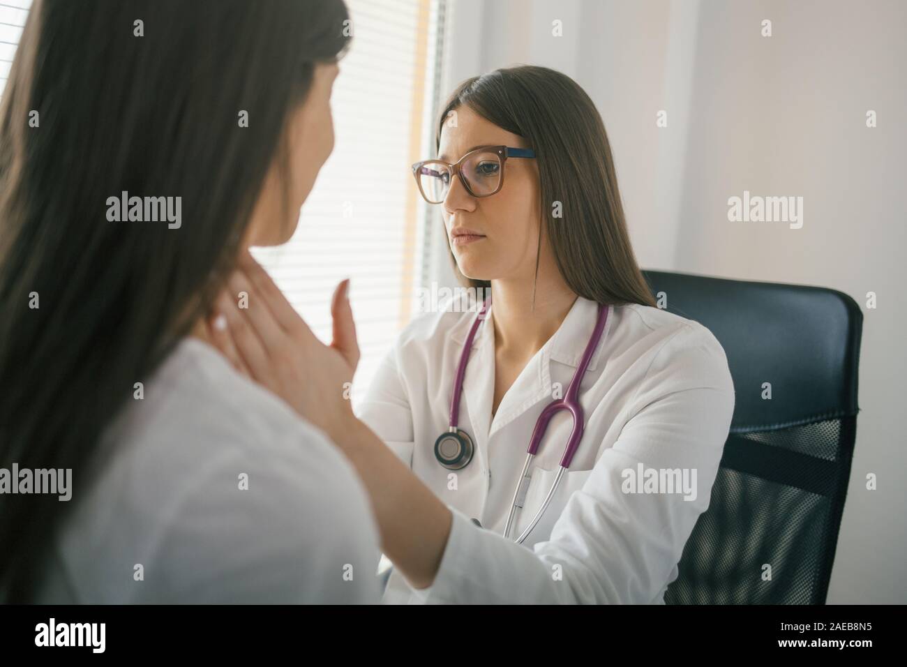 Medical exam. Female doctor palpating lymph nodes of a patient Stock Photo