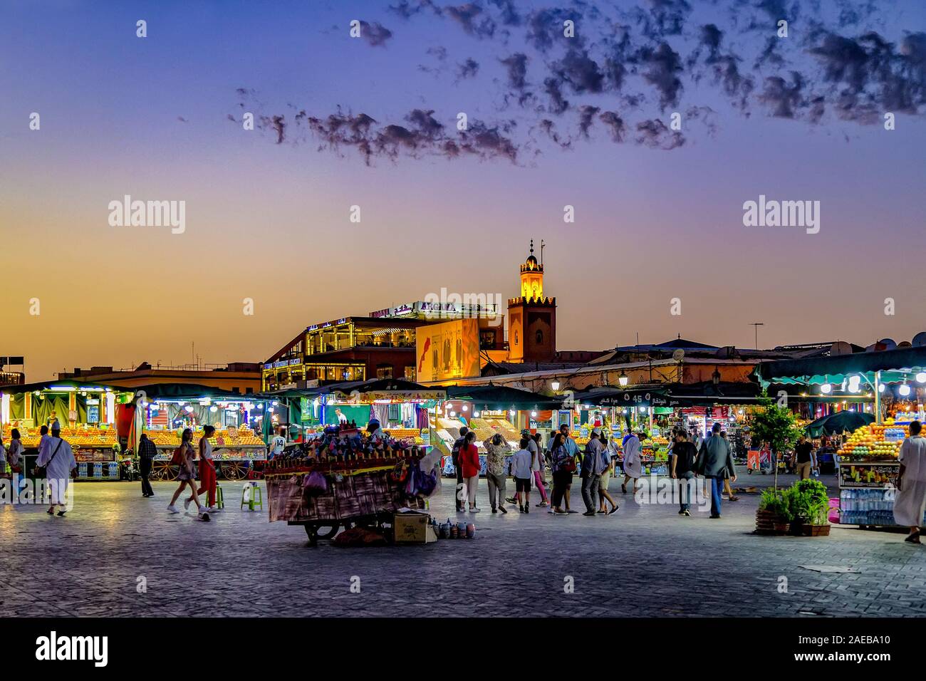 Bustling main square at sunset at UNESCO World Heritage Jamaa el Fna market square in Medina of Marrakesh,Morocco.Vendors, entertainers and tourists. Stock Photo