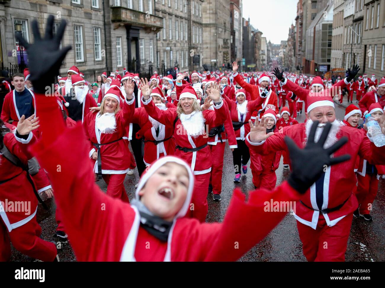 Over seven thousand members of the public taking part in Glasgow's annual Christmas Santa dash through the city centre. The Santa Dash has been held since 2006 and over the years has raised hundreds of thousands of pounds for charities working in and around Glasgow. Stock Photo
