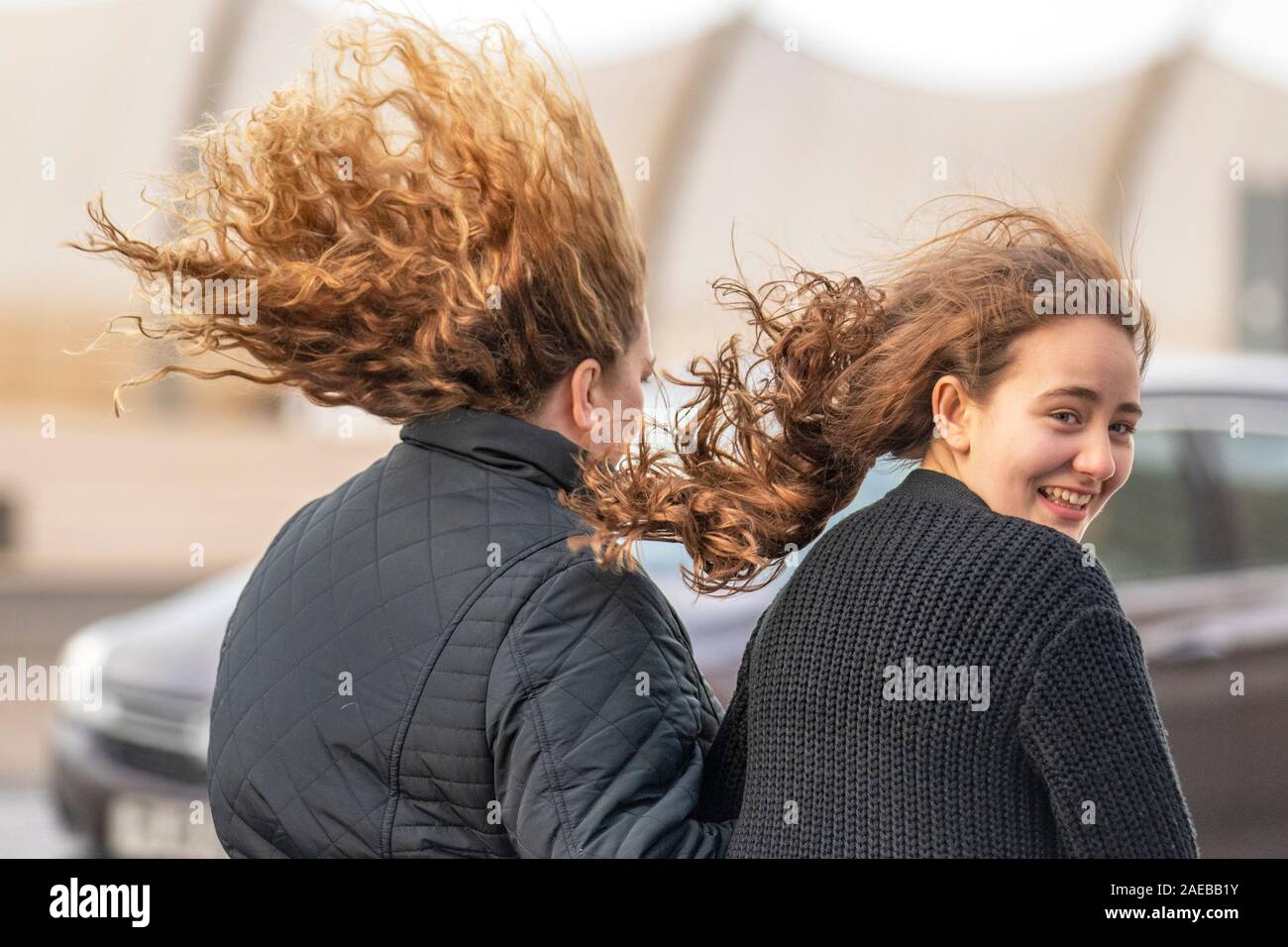 Girls hair blowing in the wind in Blackpool, UK. 08th Dec, 2019. Wet and very windy start to the day in Blackpool as Met Office forecast severe gales to batter the coast  as Storm Atiyah brings chaos to the western shores of the UK. Credit: MediaWorldImages/Alamy Live News Stock Photo