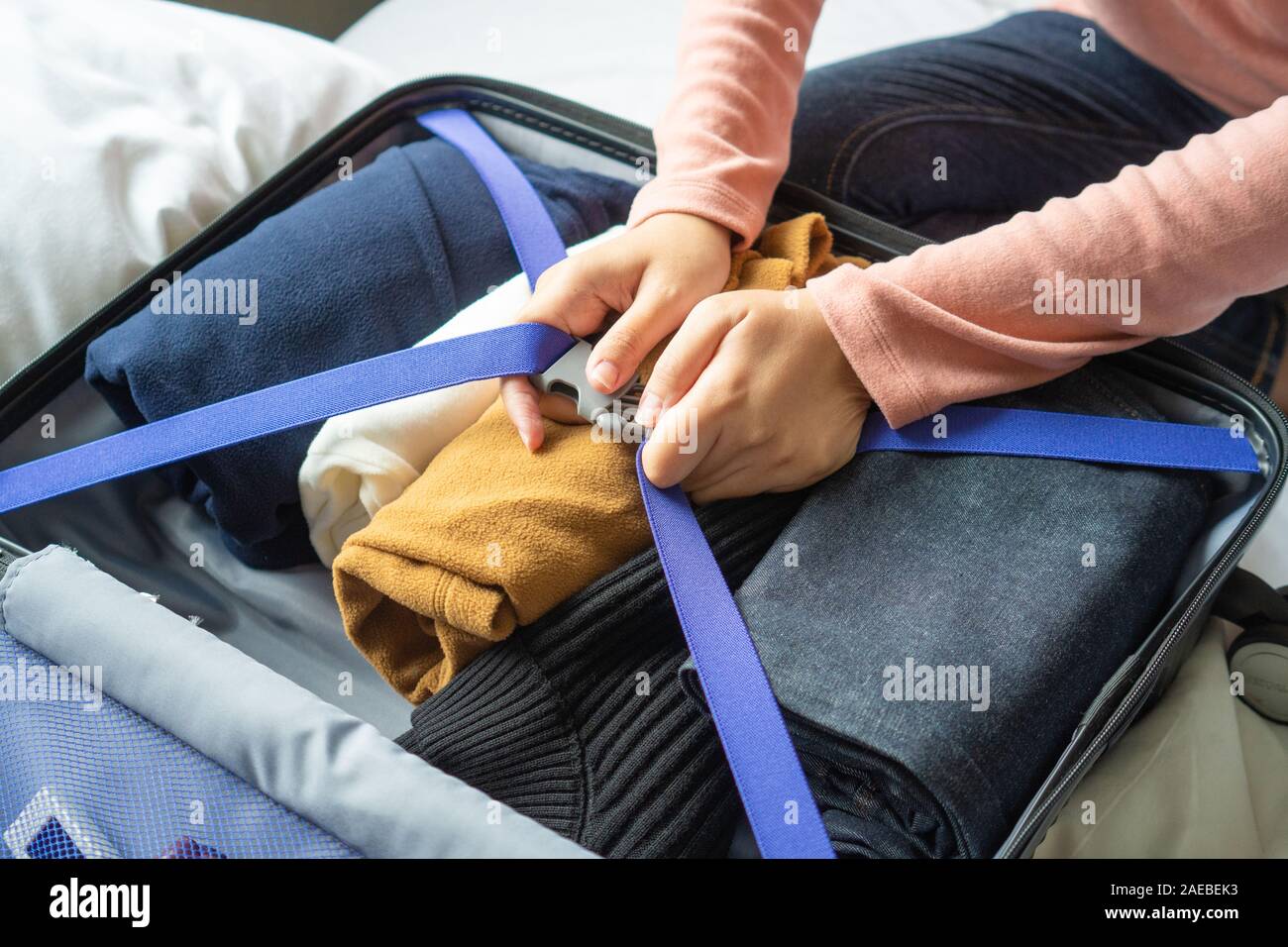 attractive girl packing suitcase for vacation Stock Photo - Alamy