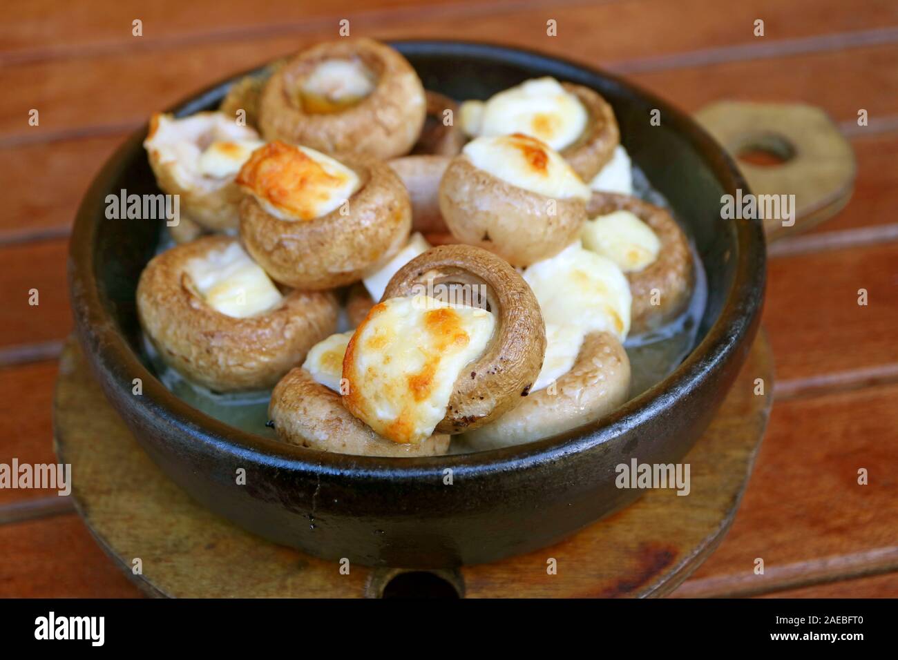 Soko Ketze or Georgian Stuffed Mushrooms with Sulguni Cheese Baked in a Ketsi Clay Dish Stock Photo