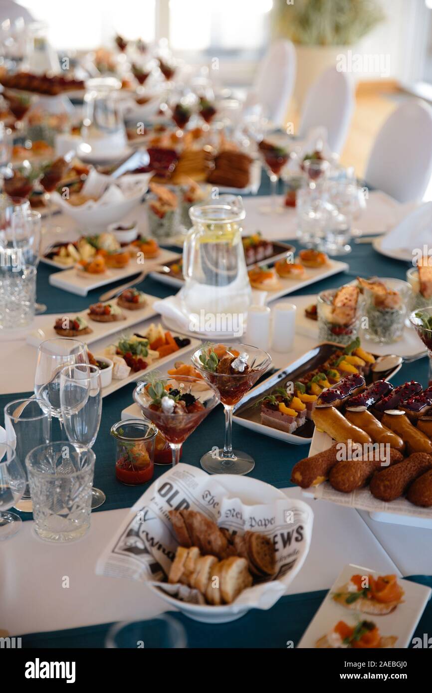 Food served on table in a white hall during a Birthday party in Eastern European Baltic Riga Latvia - Blue and teal colors - Canape, snacks and light Stock Photo