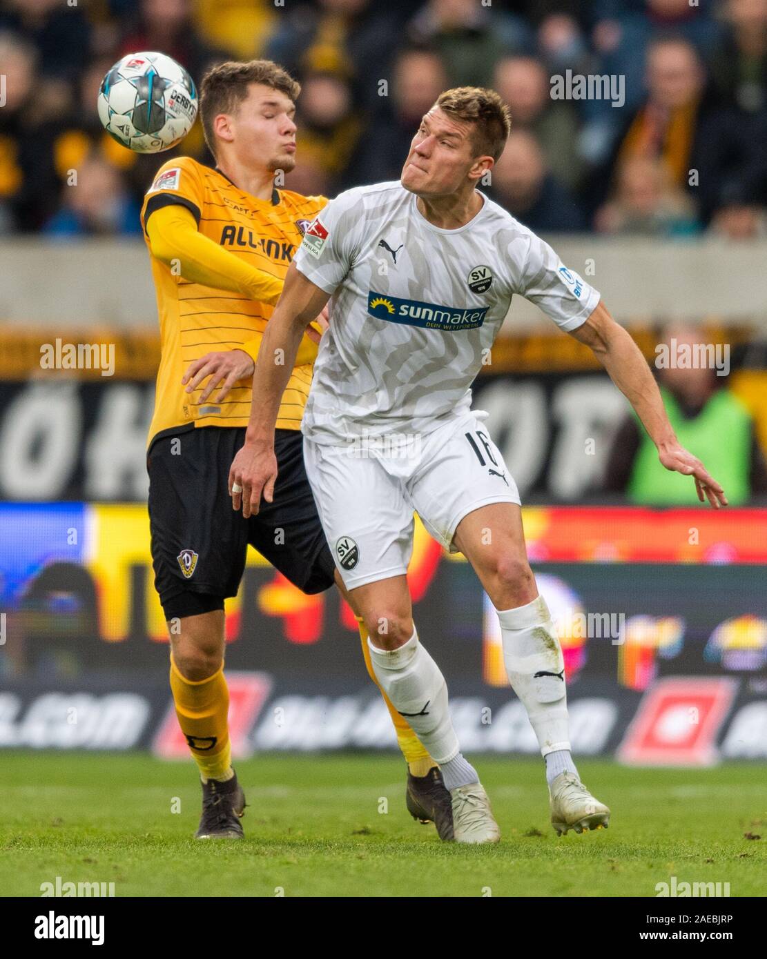 Dresden, Germany. 08th Dec, 2019. Soccer: 2nd Bundesliga, SG Dynamo Dresden - SV Sandhausen, 16th matchday, in the Rudolf Harbig Stadium. Dynamos Jannis Nikolaou (l) against Sandhausens Besar Halimi. Credit: Robert Michael/dpa-Zentralbild/dpa - IMPORTANT NOTE: In accordance with the requirements of the DFL Deutsche Fußball Liga or the DFB Deutscher Fußball-Bund, it is prohibited to use or have used photographs taken in the stadium and/or the match in the form of sequence images and/or video-like photo sequences./dpa/Alamy Live News Stock Photo