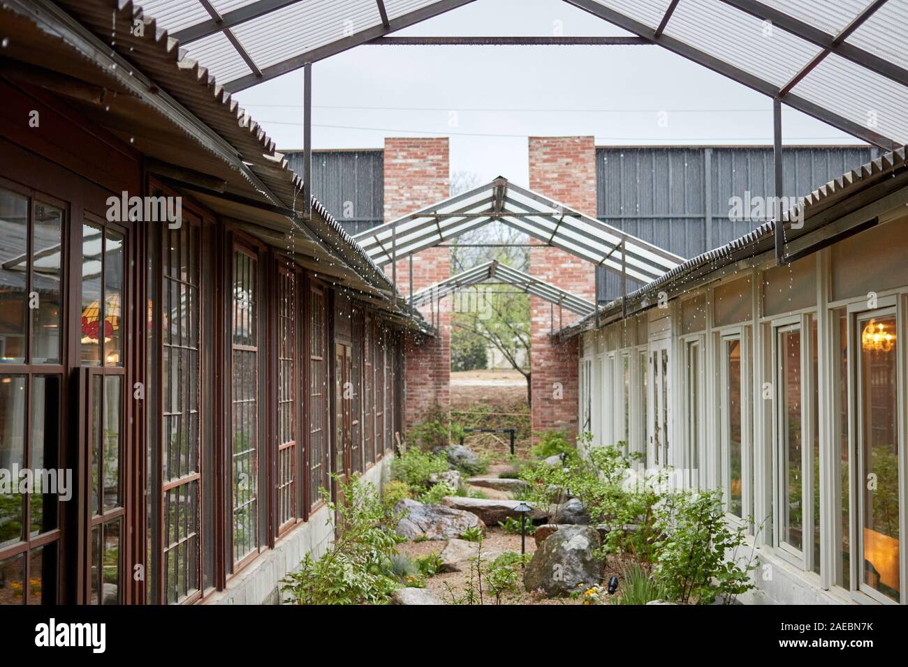 a beautiful traditional houses with a passage and small garden in a rainy day Stock Photo