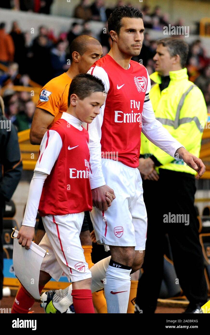 11th April 2012. Soccer - Premiership Football - Wolverhampton Wanderers Vs Arsenal. Arsenal Captain Robin Van Persie leads hist team out with a mascot.  Photographer: Paul Roberts/Oneuptop/Alamy. Stock Photo