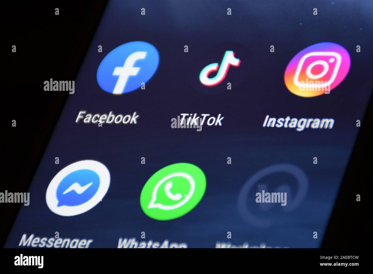 Close up view of the TikTok logo, app icon, logo displayed on a modern smartphone with other various apps Stock Photo