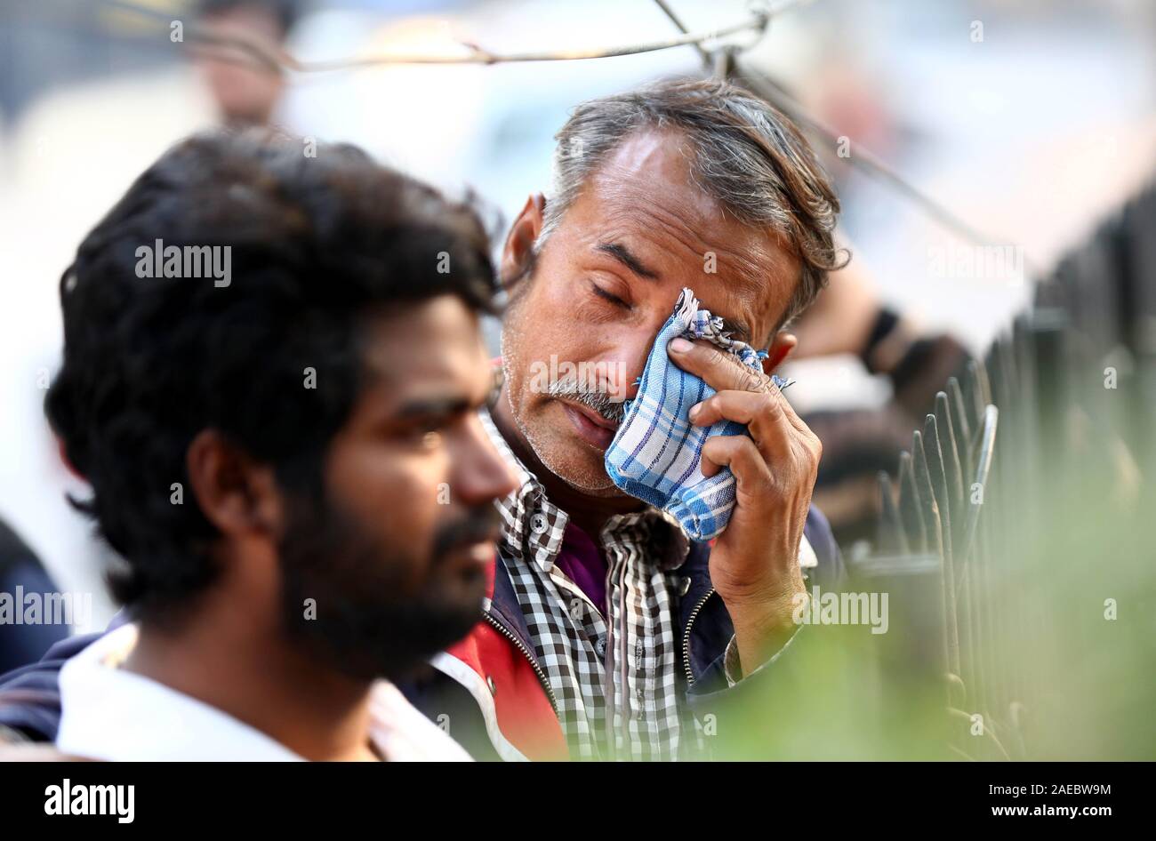 New Delhi, India. 8th Dec, 2019. Relatives of a fire victim wait at a hospital in New Delhi, India, Dec. 8, 2019. At least 43 people died and more than 50 injured in the fire incident. The injured are undergoing medical treatment at four different hospitals. The fire broke out in north Delhi's Filmistan area in the early hours of Sunday when more than 100 people, mostly labourers, were asleep inside a four-storey building. Credit: Str/Xinhua/Alamy Live News Stock Photo