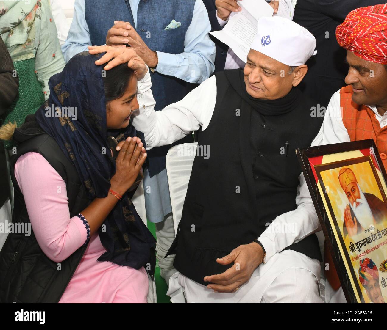 Rajasthan CM Ashok Gehlot blessings to a girl during the Shabad Kirtan held on the occasion of 550th birth anniversary of Shri Guru Nanak ji at Jaipur. Stock Photo