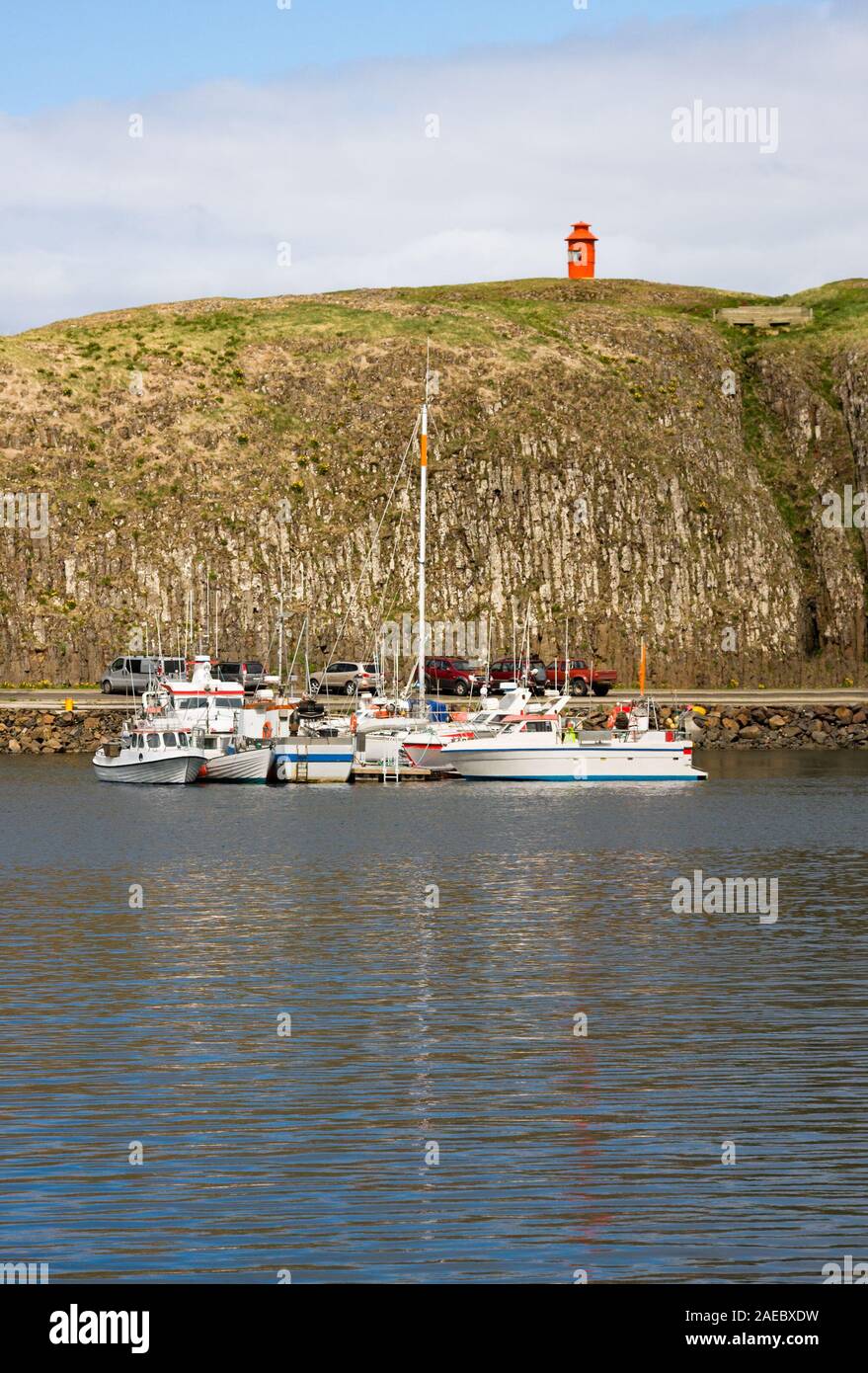 Part of the small harbor of Stykkisholmur with the famous little red lighthouse, Iceland. Stock Photo