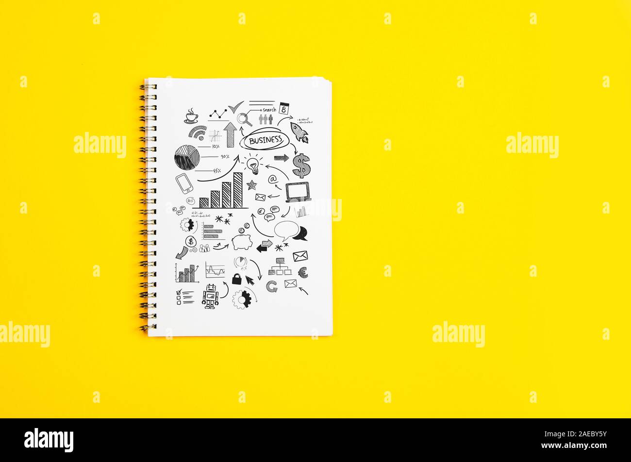 White paper page with doodles and business strategies on a yellow background Stock Photo