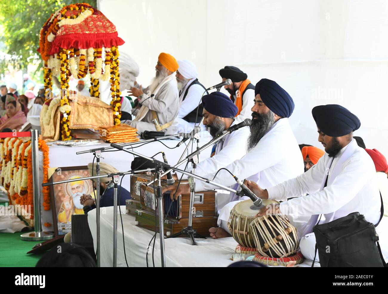 Punjabi Singer playing harmonium and singing during the Shabad Kirtan held on the occasion of 550th birth anniversary of Guru Nanak dev ji at Jaipur. Stock Photo