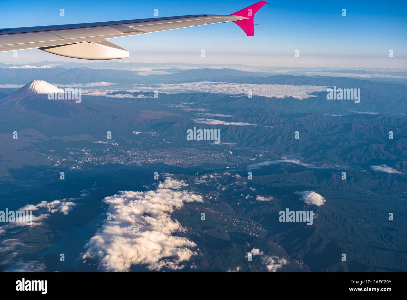 Aerial view of airplane wing with Mount Fuji ( Mt. Fuji ) in background and blue sky. Scenery landscapes of the Fuji-Hakone-Izu National Park. Gotemba Stock Photo