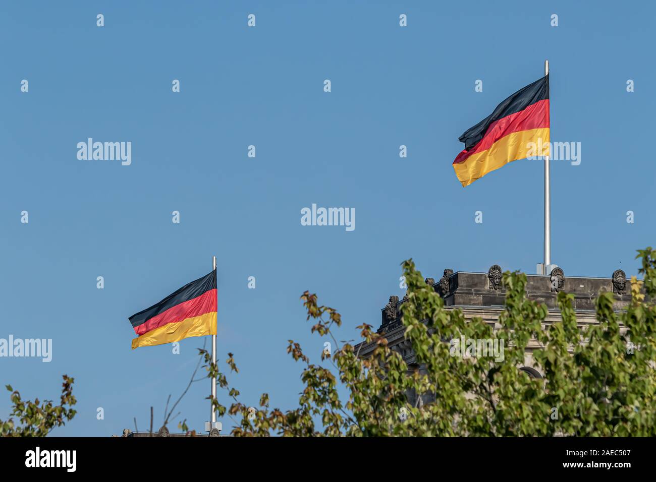 Federal Republic of Germany, German national flag waving on the blue sky background, DE Stock Photo