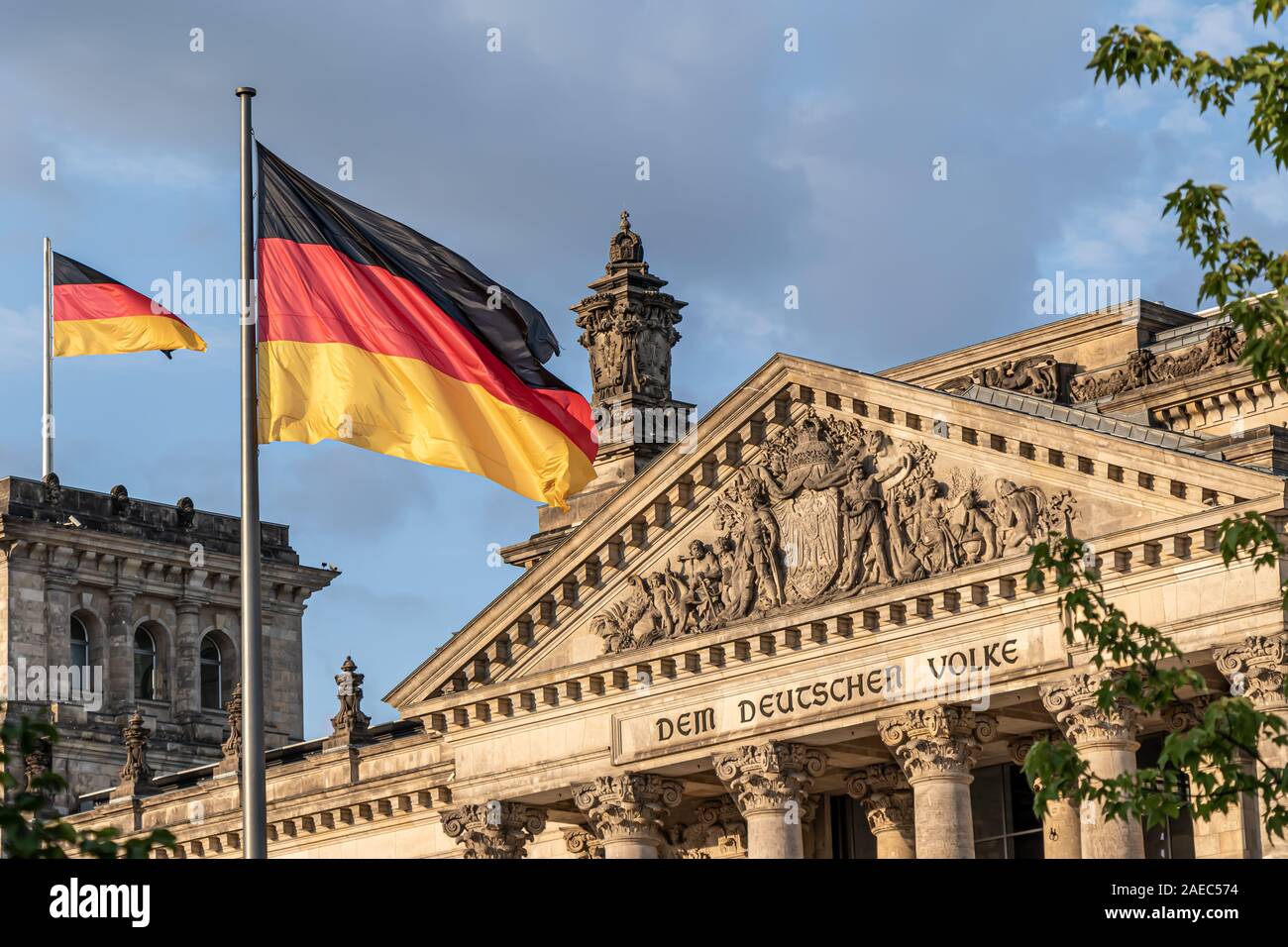 Federal Republic of Germany, German national flag at the Parliament building waving on the blue sky background, DE Stock Photo