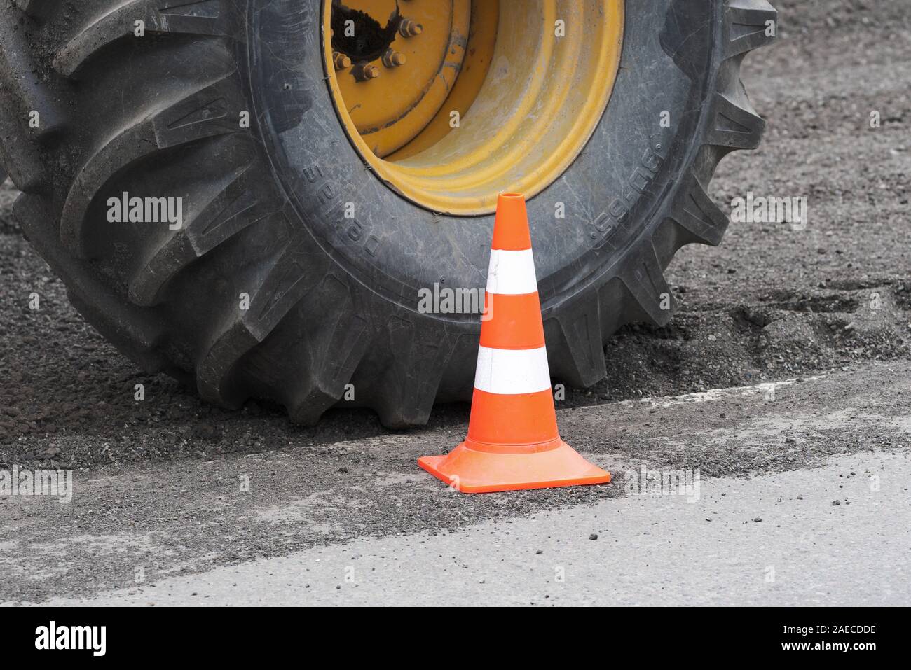 Yellow wheel with pneumatic tire produced by Petlas - Turkish tyre company. Wheel on road reclaimer Caterpillar during road restoration, traffic road Stock Photo