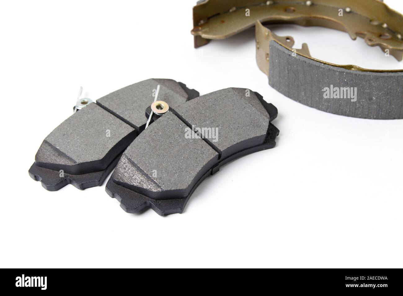 Brake pads and brake discs for cars isolated on white background. New