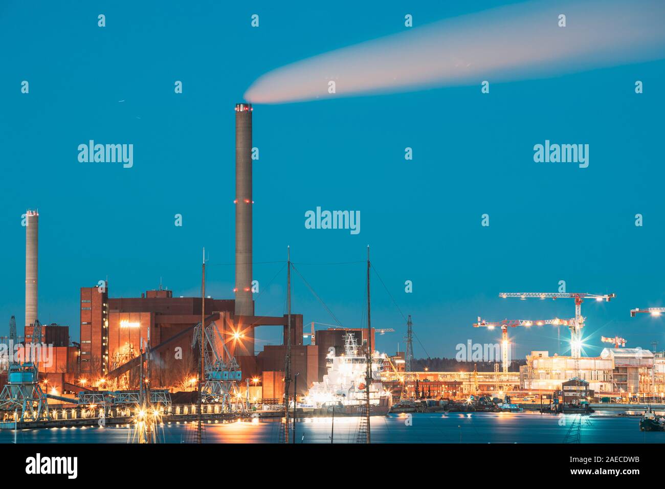 Helsinki, Finland - December 10, 2016: Evening Night View Of Industrial Zone Of Hanasaari Power Plant And Pier, Berth With Moored Ships, Vessels. Nigh Stock Photo