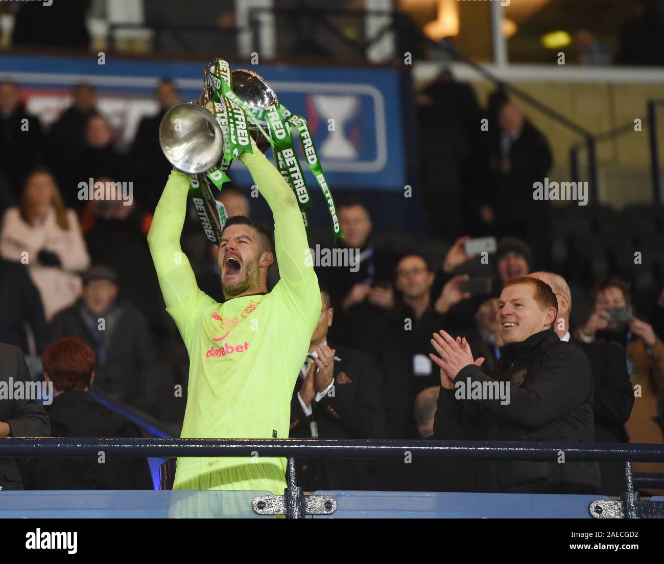 Hampden Park, Glasgow. Scotland.UK.8th Dec 2019. Rangers vs Celtic. Betfred, Scottish League Cup Final.   Celtic Hero keeper Fraser Forster (Penalty save) with trophy as manager   Neil Lennon looks on. Credit: eric mccowat/Alamy Live News Stock Photo