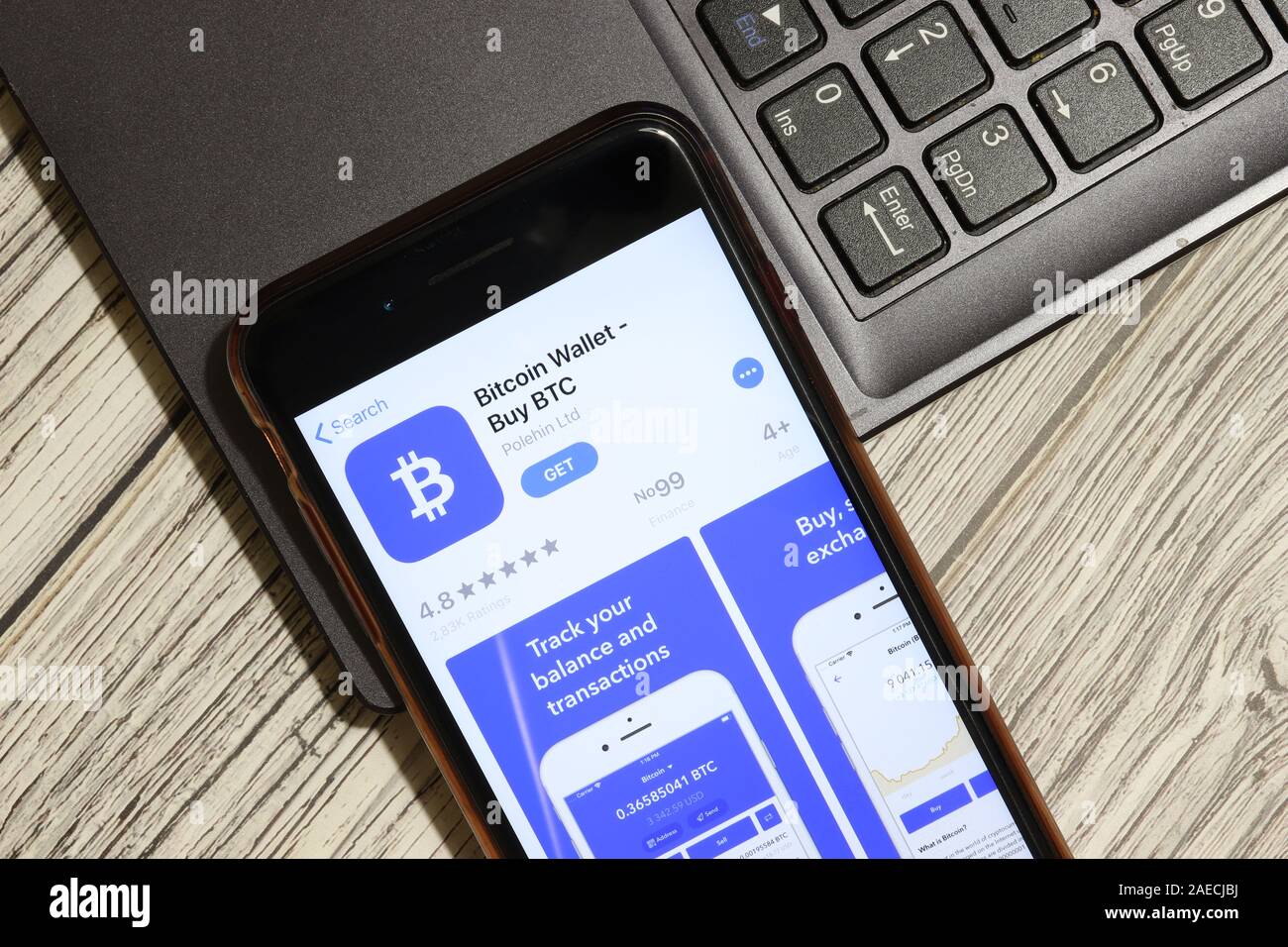 Los Angeles, California, USA - 3 December 2019: Bitcoin Wallet App Logo on phone screen with laptop flat lay, Illustrative Editorial. Stock Photo