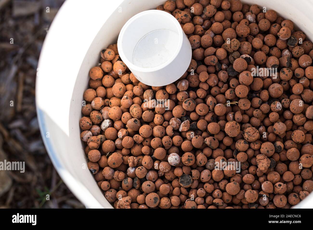 Round red light weight volcanic landscaping rock Stock Photo - Alamy