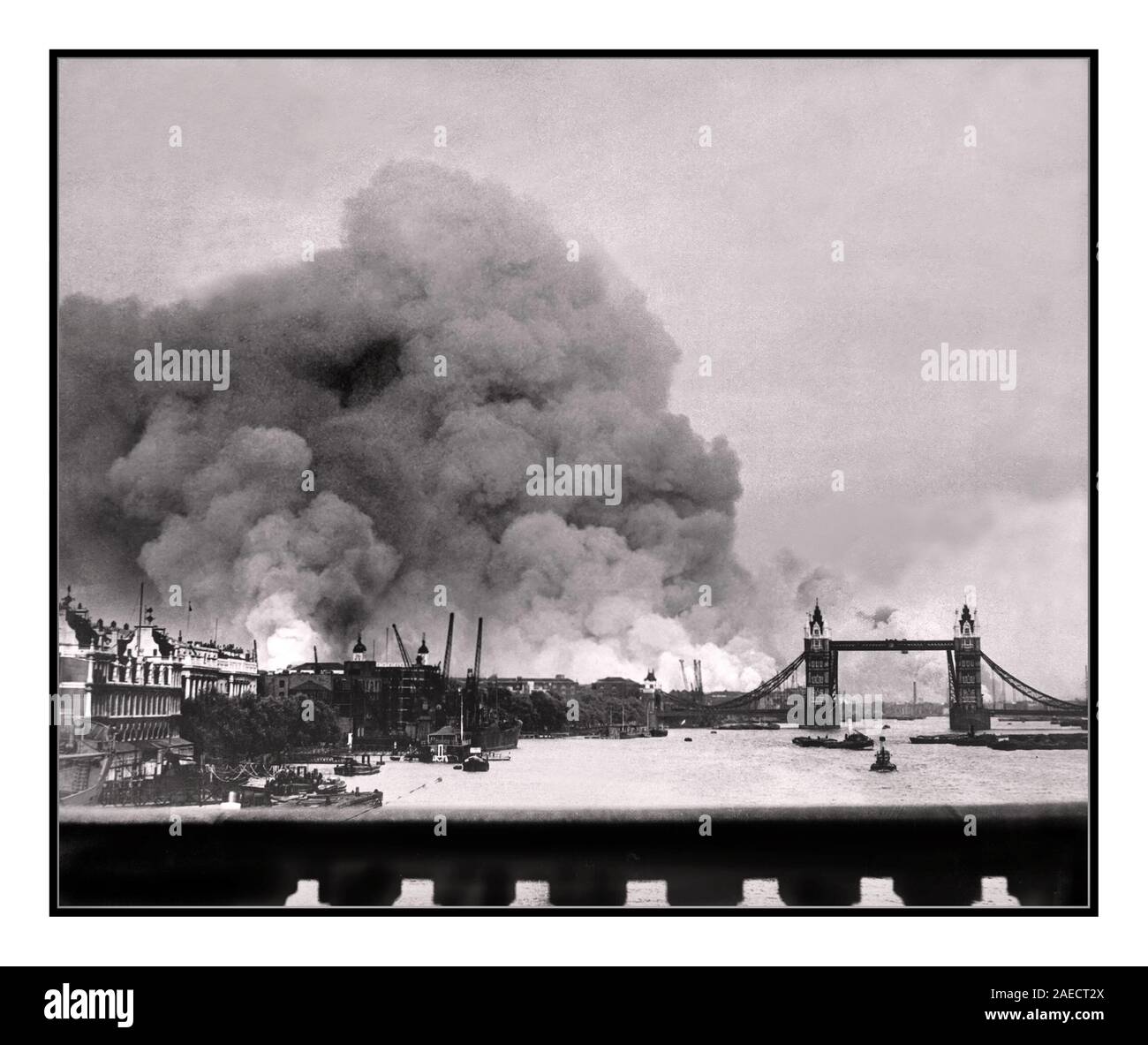 TOWER BRIDGE 1940's London Blitz Vintage image made during the first mass blitz bombing air raid on London, 7th September 1940, the scene in London’s docklands area. Tower Bridge (painted black to reduce its visibility) featured standing against a background of smoke and fires from Nazi Germany Luftwaffe terror bombing Stock Photo