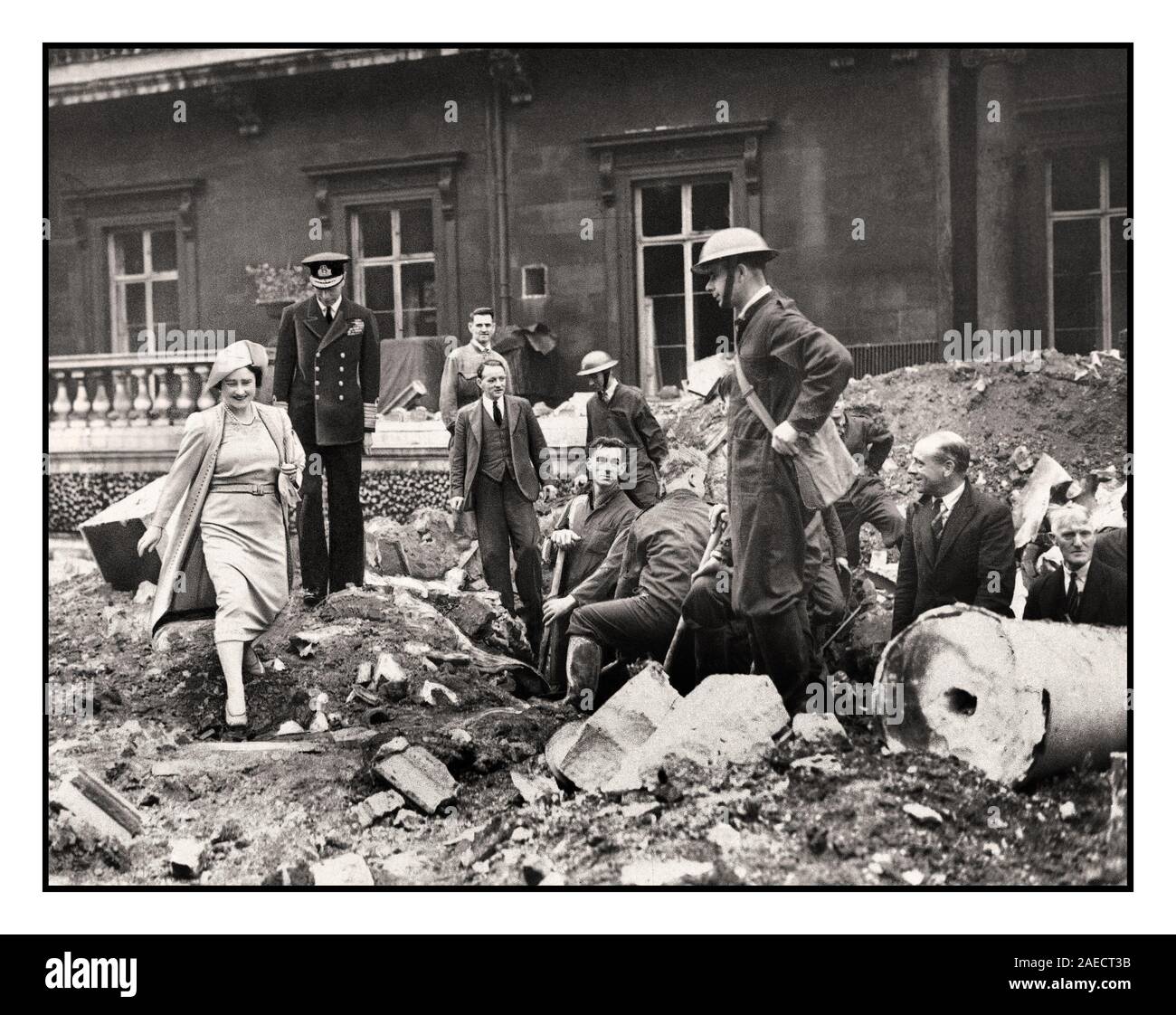 1940's London Blitz Royal Family Vintage WW2 image of King George VI and Queen Elizabeth inspecting the bomb damage at Buckingham Palace London during World War II  giving a morale boost to the workers clearing the rubble. Elizabeth and her husband King George VI embodied the spirit of British stoicism during the major conflict. In 1940, as London was blitzed relentlessly by the Germans, Queen Elizabeth and the King would tirelessly tend to those affected by the bombing offensive, visiting bombed civilians and devastated businesses and industries. Stock Photo