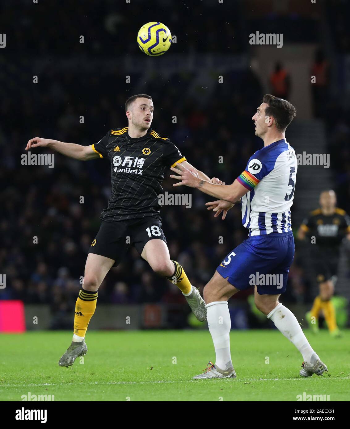 Diogo Jota of Wolves (L) vies for the ball against Brighton's Lewis Dunk (R) during the Premier League match between Brighton & Hove Albion and Wolverhampton Wanderers at The Amex Stadium in Brighton. 08 December 2019 Stock Photo