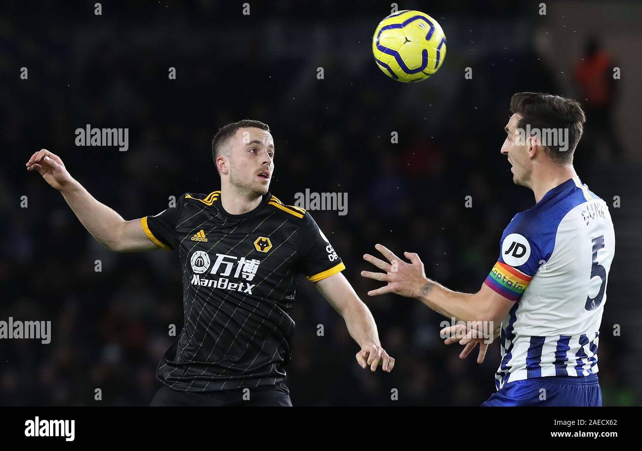 Diogo Jota of Wolves (L) vies for the ball against Brighton's Lewis Dunk (R) during the Premier League match between Brighton & Hove Albion and Wolverhampton Wanderers at The Amex Stadium in Brighton. 08 December 2019 Stock Photo