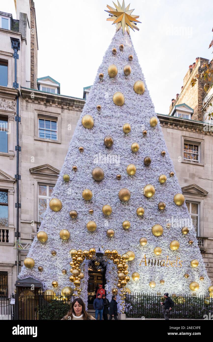 Annabel's private members club with towering Christmas tree shaped decoration on the front of the building. Berkley Square, Mayfair, London, England, Stock Photo