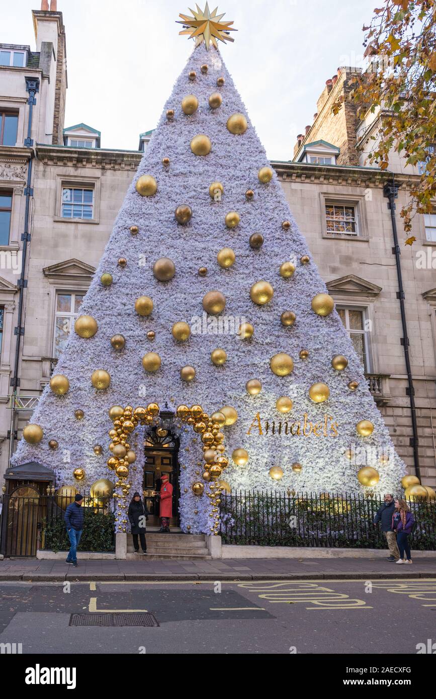 Annabel's private members club with towering Christmas tree shaped decoration on the front of the building. Berkley Square, Mayfair, London, England, Stock Photo