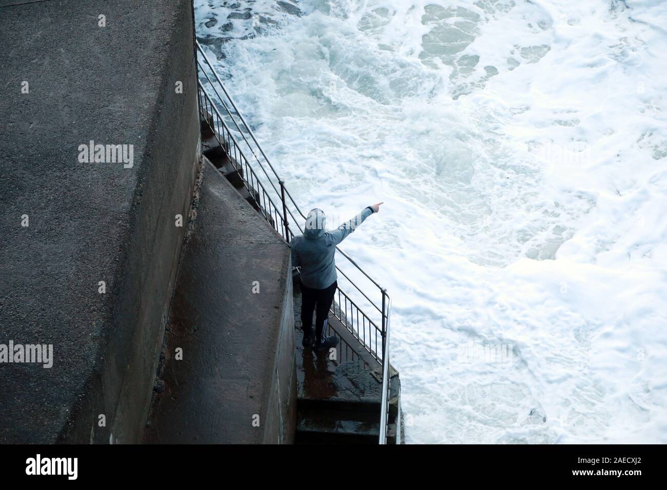 Ilfracombe, Devon, UK. 8th Dec, 2019. Storm Atiyah hits the coast of Ilfracombe, a seaside resort in North Devon, high winds and large waves batter the coastline. People come out to watch as the large waves hit the harbour walls. Credit: Natasha Quarmby/17�Թ����� Live News Stock Photo