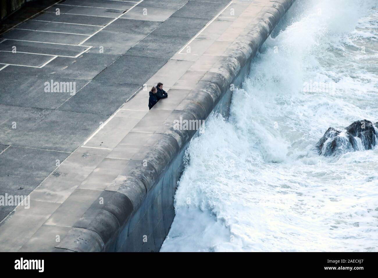 Ilfracombe, Devon, UK. 8th Dec, 2019. Storm Atiyah hits the coast of Ilfracombe, a seaside resort in North Devon, high winds and large waves batter the coastline. People come out to watch as the large waves hit the harbour walls. Credit: Natasha Quarmby/17�Թ����� Live News Stock Photo