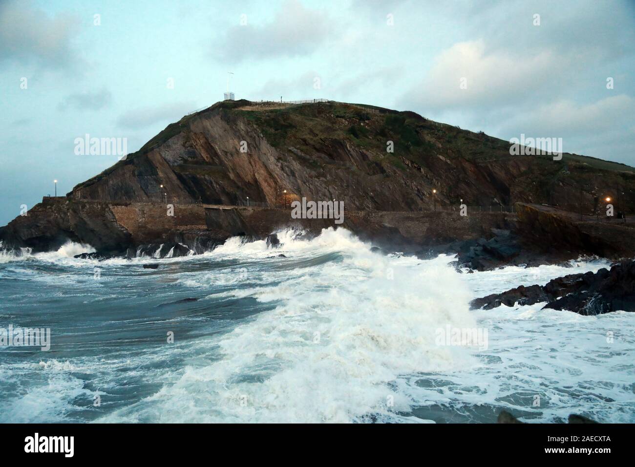 Ilfracombe, Devon, UK. 8th Dec, 2019. Storm Atiyah hits the coast of Ilfracombe, a seaside resort in North Devon, high winds and large waves batter the coastline. People come out to watch as the large waves hit the harbour walls. Credit: Natasha Quarmby/17�Թ����� Live News Stock Photo