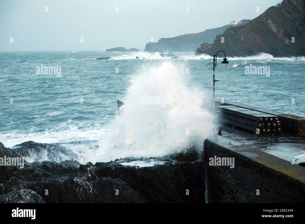 Ilfracombe, Devon, UK. 8th Dec, 2019. Storm Atiyah hits the coast of Ilfracombe, a seaside resort in North Devon, high winds and large waves batter the coastline. People come out to watch as the large waves hit the harbour walls. Credit: Natasha Quarmby/17�Թ����� Live News Stock Photo
