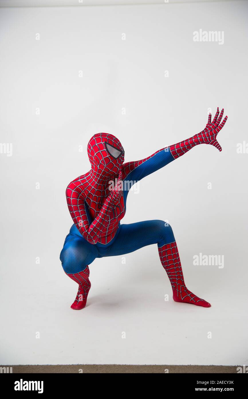 December 1, 2019. Israel, tel Aviv. Spiderman posing on a white background, the animator dressed as a spider in the pose concept of entertainment Stock Photo