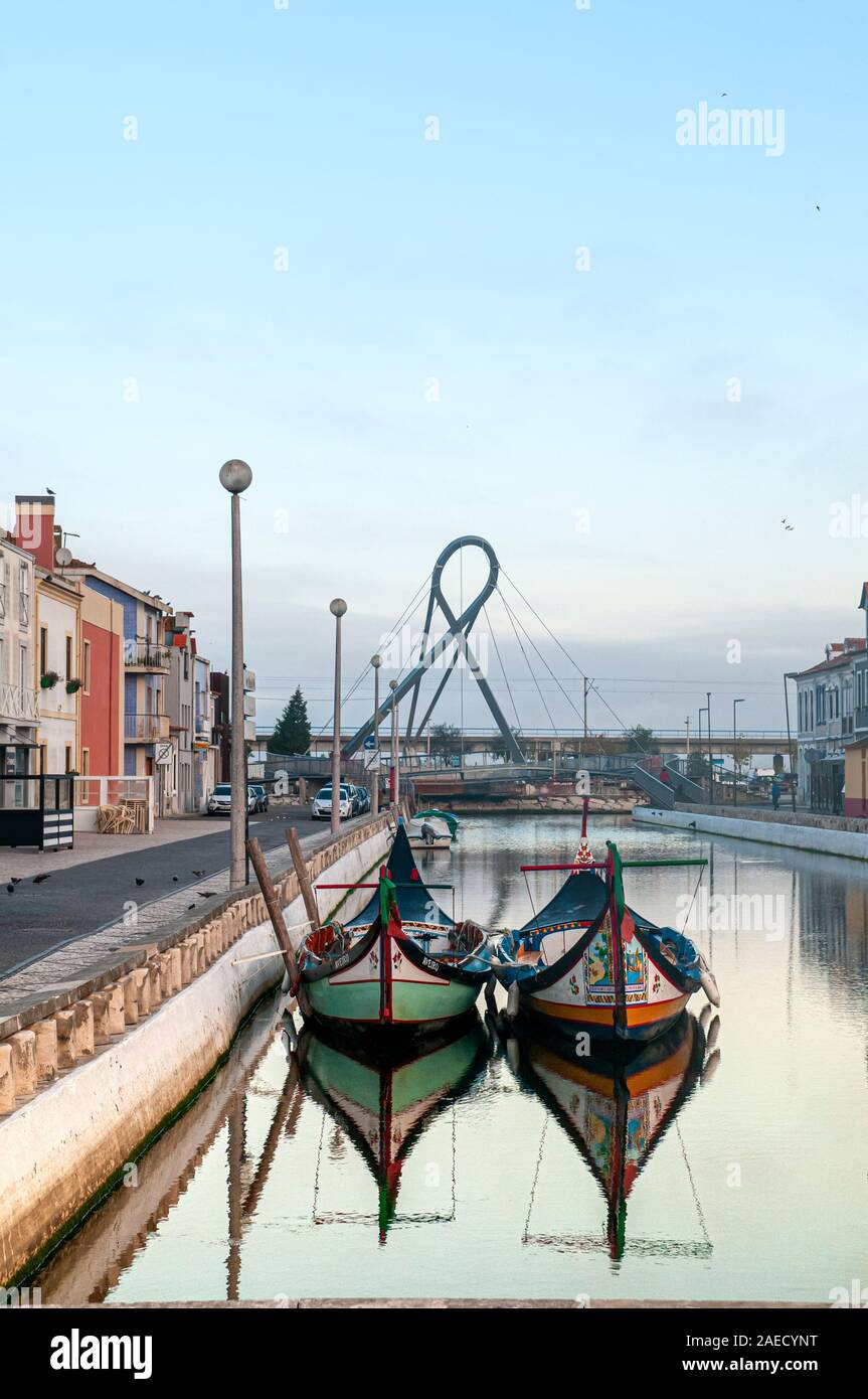 Traditional Portuguese boat (barcos moliceiros Originally used for collecting seaweed) moored in a canal, Aveiro, Portugal at dawn Stock Photo