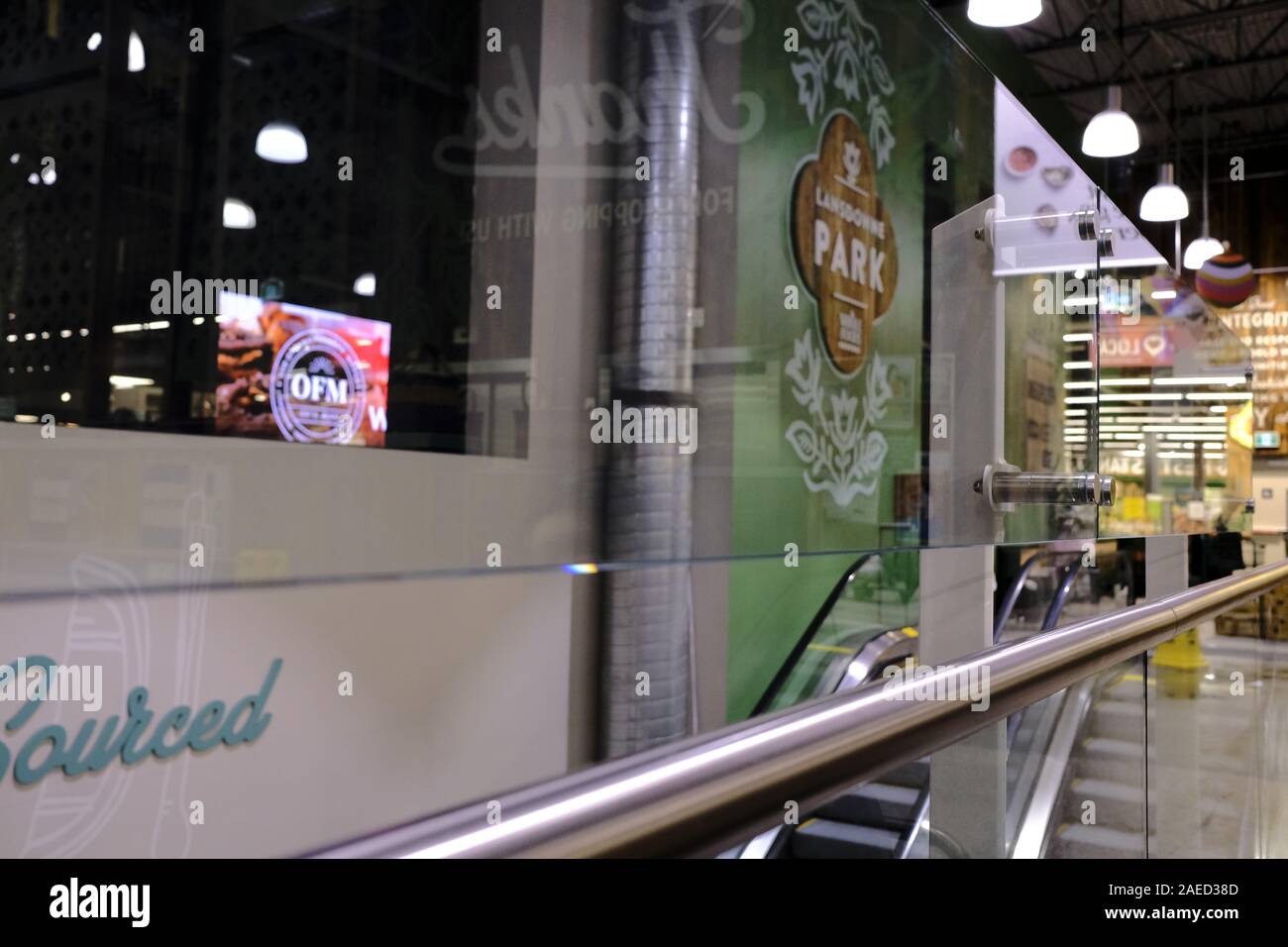 Glass barrier and escalators at the food court of Whole Foods Market