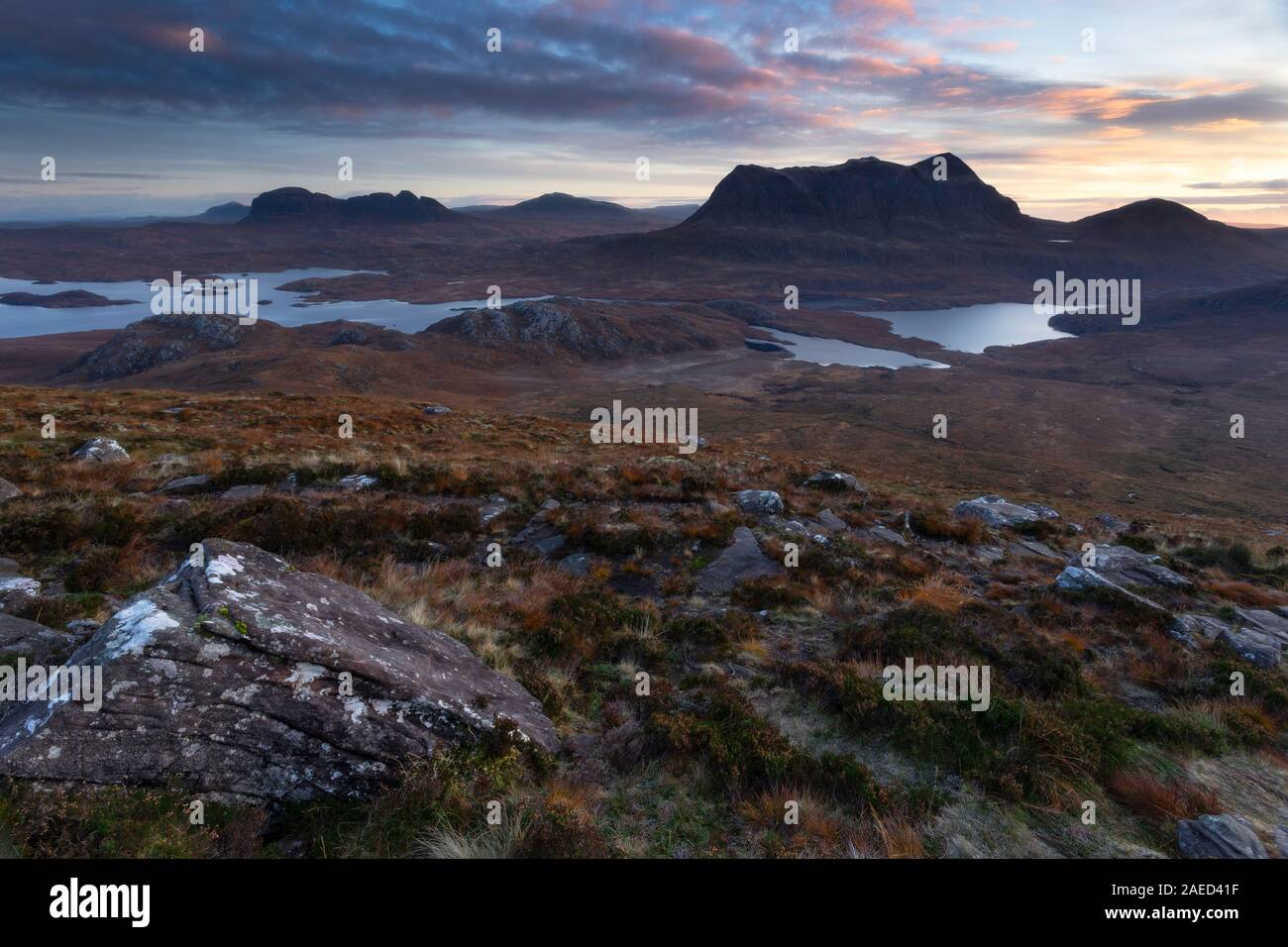 Cul Mor and Suilven mountains at dawn as seen from the slopes of Stac Pollaidh in Assynt in the Northwest Highlands of Scotland Stock Photo