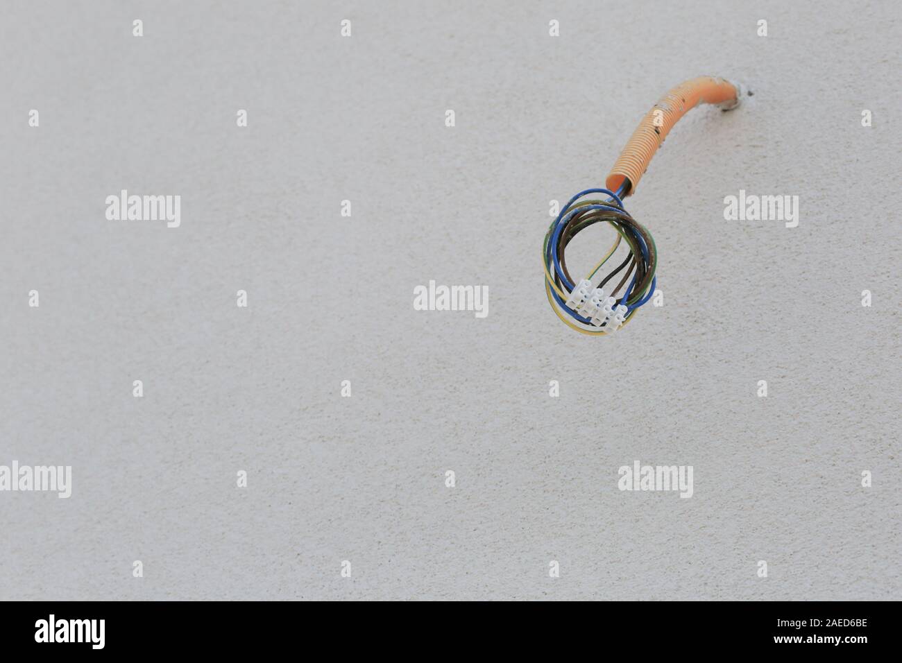 Electric wiring on the building facade for outdoor lighting Stock Photo