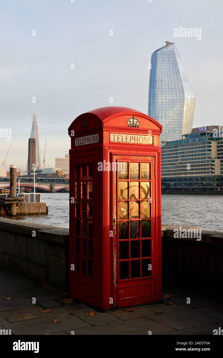 RED TELEPHONE BOX ALONG THAMES RIVER WITH THE SHARD AND ONE BLACKFRIARS BUILDINGS IN THE BACKGROUND - LONDON CITY CITYSCAPE - G.G.SCOTT - TELEPHONE CABIN - LONDON ENGLAND © Frédéric BEAUMONT Stock Photo