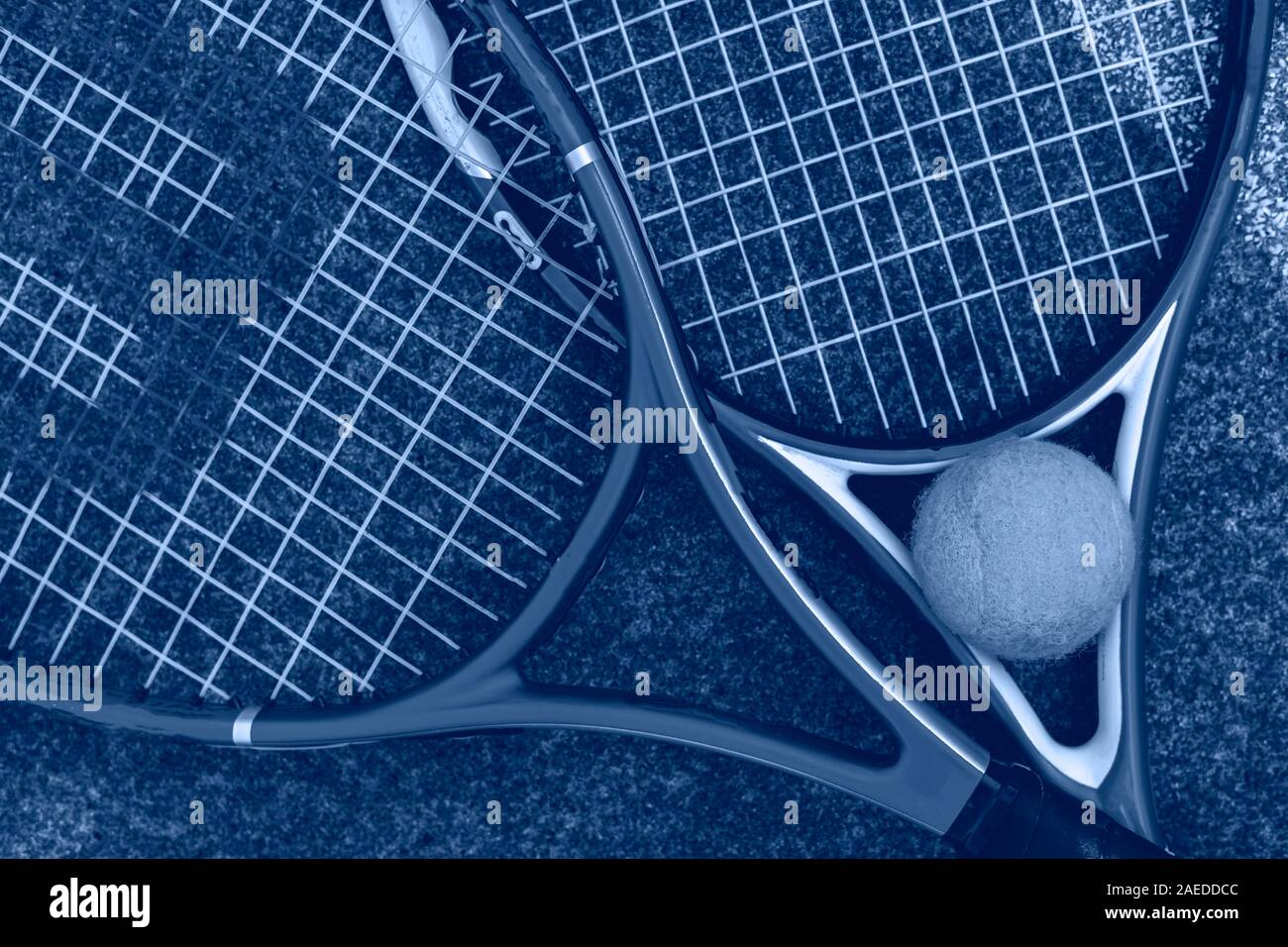 top overhead view of two tennis rackets with the ball on the ground of the court outdoors concept Stock Photo