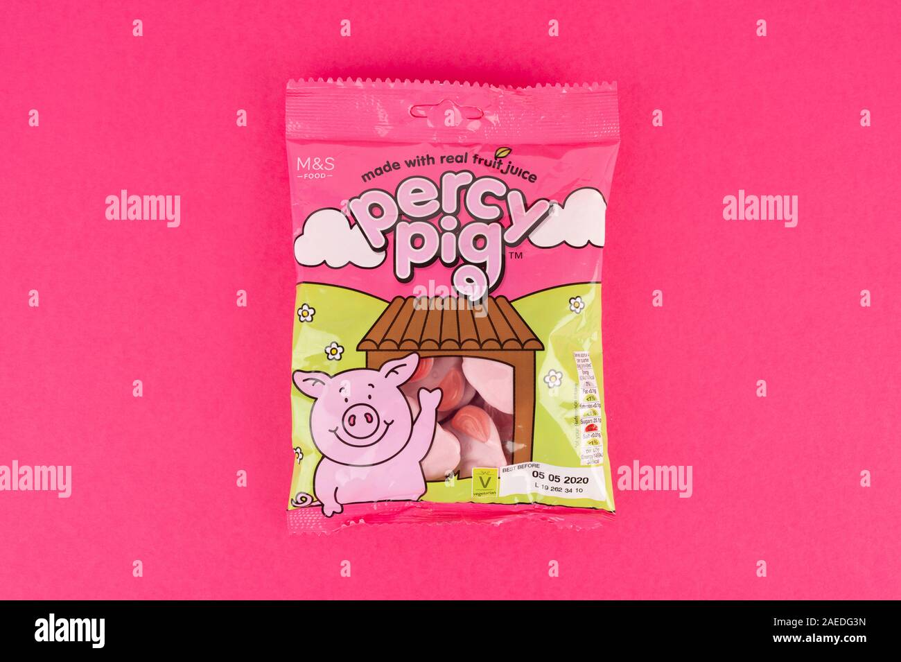 A packet of M&S Percy Pig sweets shot on a pink background. Stock Photo