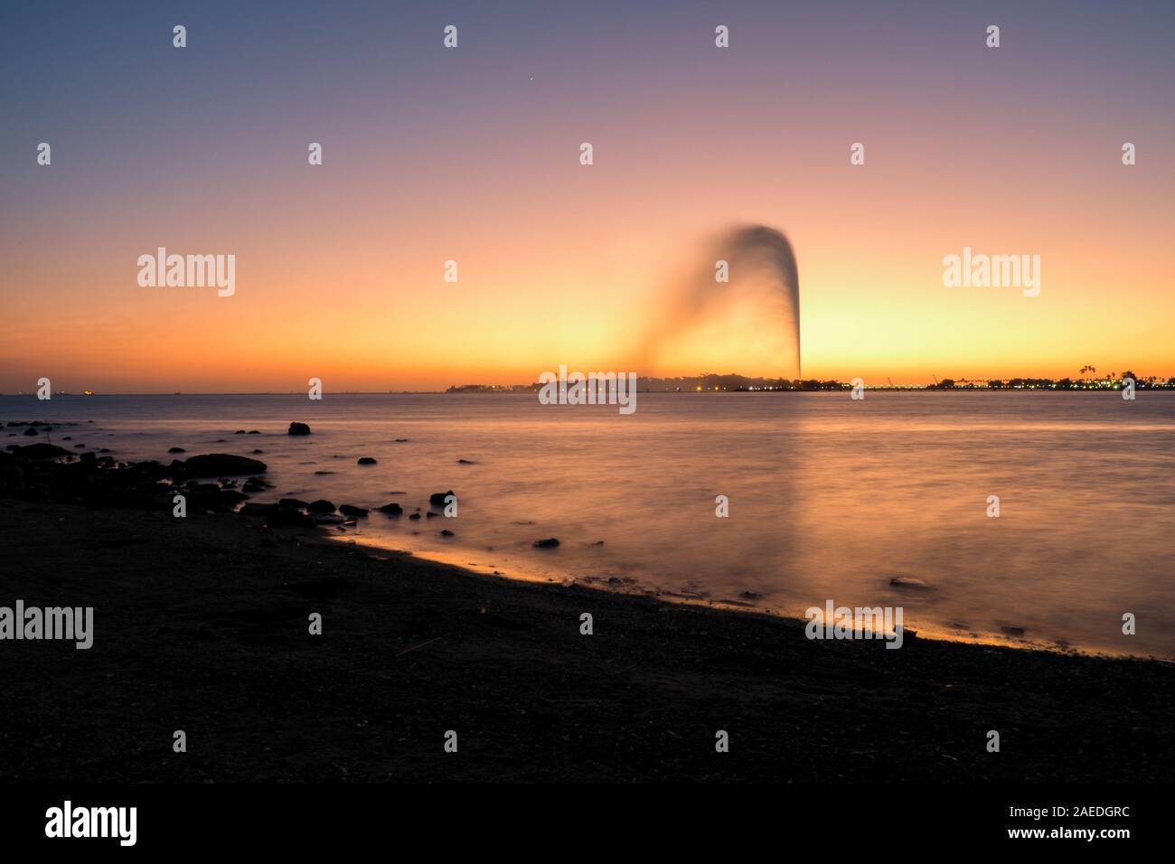 View of the King Fahd's Fountain seen from the South Corniche, Jeddah, Saudi Arabia, with a beautiful sunset in the background Stock Photo