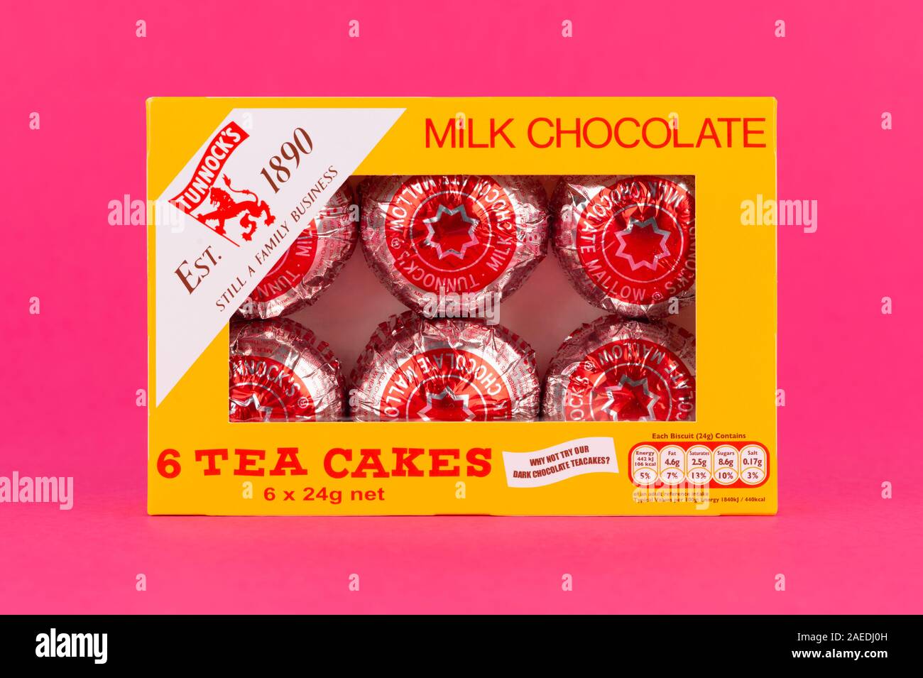 A box of six Tunnock's Milk Chocolate Tea Cakes shot on a pink background. Stock Photo