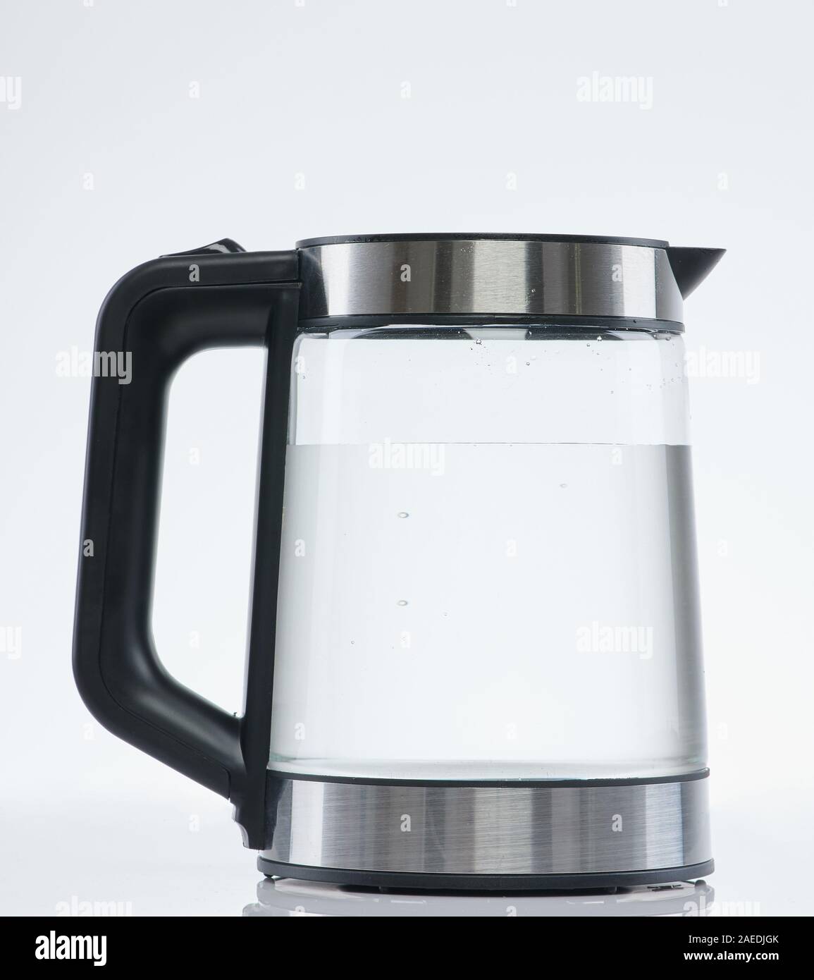 Clean water in transparent kettle isolated on white studio background