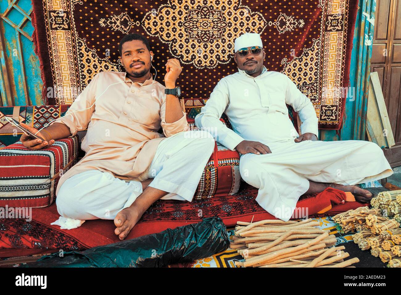 Two Arabic men sell miswak teeth cleaning twigs on the Souk Baab Makkah street market at the